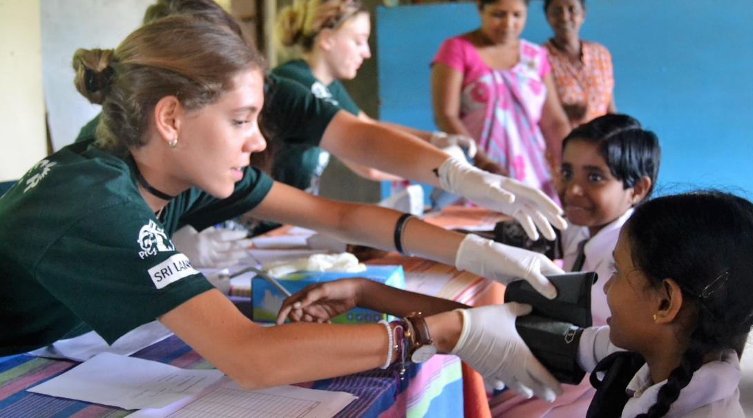 A group of interns measure blood pressure levels of local children and gain work experience as part of their public health internship in Sri Lanka. A group of interns are pictured measuring blood pressure levels as part of their public health internship in Sri Lanka.